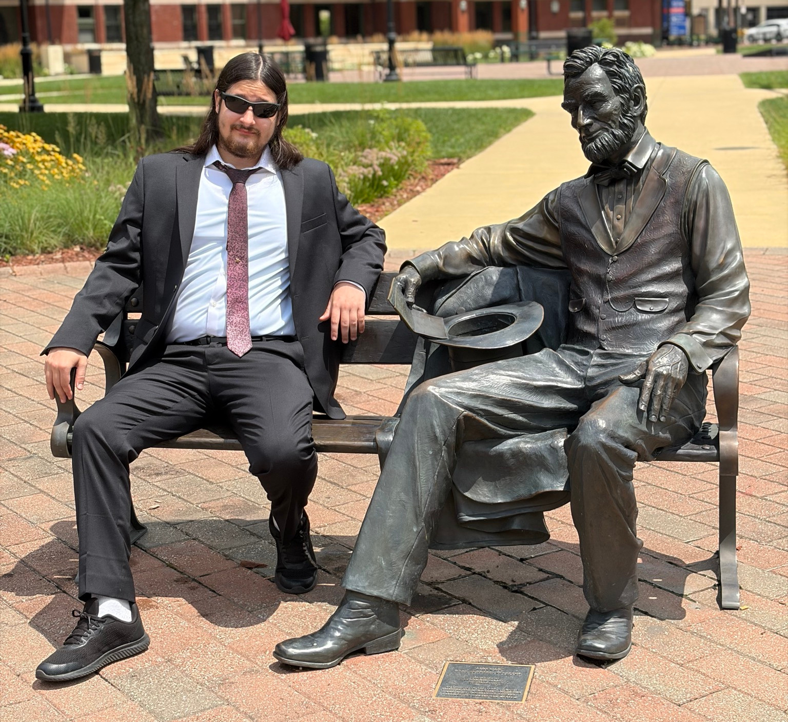 Reece sitting with Lincoln on bench.